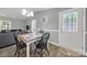 Cozy dining area with a wooden table, black chairs, and a view into the living room at 6705 Reddman Rd, Charlotte, NC 28212