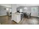 Open-concept dining area with gray walls, wooden floors and view of the living room at 6705 Reddman Rd, Charlotte, NC 28212