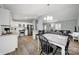 Open kitchen featuring modern white cabinets, stainless steel appliances, and an adjacent dining area at 6705 Reddman Rd, Charlotte, NC 28212