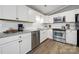 Updated kitchen boasts stainless appliances, white cabinets and gray granite countertops at 6705 Reddman Rd, Charlotte, NC 28212