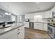 Bright kitchen featuring stainless appliances, white cabinets, gray countertop island, and eating area at 6705 Reddman Rd, Charlotte, NC 28212