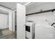 Convenient laundry area features white washer and dryer, plus shelving for storage at 6705 Reddman Rd, Charlotte, NC 28212