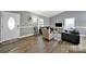 Bright and airy living room with hardwood floors, comfortable seating, and a welcoming atmosphere at 6705 Reddman Rd, Charlotte, NC 28212