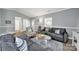 Spacious living room featuring comfortable seating, hardwood flooring, and a view of the front door at 6705 Reddman Rd, Charlotte, NC 28212