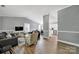 Open-concept living room with modern decor, hardwood floors, and plenty of natural light at 6705 Reddman Rd, Charlotte, NC 28212