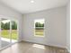 Bright bedroom with a sliding glass door and large window at 7129 Jerimoth Dr, Charlotte, NC 28215