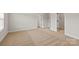 Spacious bedroom with neutral carpet, two entry doors, and a walk-in closet at 7129 Jerimoth Dr, Charlotte, NC 28215