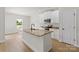 Open kitchen featuring a granite island, white cabinets, and modern appliances at 7129 Jerimoth Dr, Charlotte, NC 28215