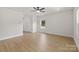 Bright living room with wood-look flooring, neutral walls, and ceiling fan at 7129 Jerimoth Dr, Charlotte, NC 28215