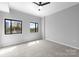Serene bedroom with neutral carpet, a ceiling fan, and natural light from the windows at 715 N Church St # 513, Charlotte, NC 28202