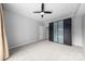 Open bedroom with a ceiling fan, neutral carpet, and modern dark blue closet at 715 N Church St # 513, Charlotte, NC 28202