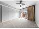 Spacious bedroom with a ceiling fan, neutral carpet, and a sliding glass door to a balcony at 715 N Church St # 513, Charlotte, NC 28202