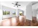 Open concept living room featuring hardwood floors, natural light, and a ceiling fan at 715 N Church St # 513, Charlotte, NC 28202