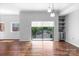 Sunlit living room with dark hardwood floors and large windows with green tree views at 715 N Church St # 513, Charlotte, NC 28202
