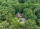 Secluded home nestled among dense trees, offering privacy and a connection with nature from above at 715 White Oaks Cir, Monroe, NC 28110