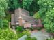 Aerial view of a charming home surrounded by lush greenery, showcasing its serene and private setting at 715 White Oaks Cir, Monroe, NC 28110
