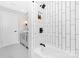 Stylish bathroom showcasing a tub with white subway tile, a niche, and a gray vanity with modern black fixtures at 715 White Oaks Cir, Monroe, NC 28110
