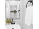 Updated half bath featuring a black faucet and mirror, white sink, and decorative plant accents at 715 White Oaks Cir, Monroe, NC 28110