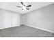 Neutral bedroom with a closet, ceiling fan, plush gray carpet, and a door providing plenty of space at 715 White Oaks Cir, Monroe, NC 28110