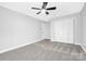 Bright bedroom with a closet, plush carpet, and bright ceiling fan, providing plenty of space at 715 White Oaks Cir, Monroe, NC 28110