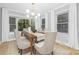 Bright dining room features a dining table, six chairs, pendant lighting, and light-filled windows at 715 White Oaks Cir, Monroe, NC 28110
