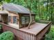 Exterior deck with wood railings, showcasing a unique tree feature and outdoor living space at 715 White Oaks Cir, Monroe, NC 28110