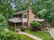 Charming home with wood siding, inviting front porch, and lush landscaping, offering great curb appeal at 715 White Oaks Cir, Monroe, NC 28110