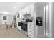 Bright kitchen with white cabinets, stainless steel appliances, and a dining area with natural light at 715 White Oaks Cir, Monroe, NC 28110
