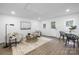 Bright living room featuring modern decor, wood floors, and ample natural light from multiple windows at 715 White Oaks Cir, Monroe, NC 28110