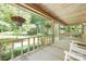 Spacious front porch with hanging flower baskets and a scenic view of the green landscape at 715 White Oaks Cir, Monroe, NC 28110
