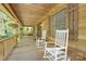 Inviting front porch featuring classic rocking chairs and a rustic wood design, perfect for enjoying the outdoors at 715 White Oaks Cir, Monroe, NC 28110