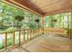 Inviting covered front porch with a wooden swing and lovely view of the surrounding landscape at 715 White Oaks Cir, Monroe, NC 28110