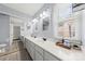 Bright bathroom featuring a dual sink vanity, quartz countertops, and decorative framed mirrors at 7425 Hubbard Woods Rd, Charlotte, NC 28269