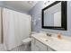 Bathroom featuring a single sink vanity, black framed mirror and patterned floors at 7425 Hubbard Woods Rd, Charlotte, NC 28269