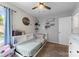Cozy bedroom with a ceiling fan and a built-in headboard with shelving at 7425 Hubbard Woods Rd, Charlotte, NC 28269
