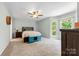 Bedroom with neutral carpet, ceiling fan, and views of the outdoors at 7425 Hubbard Woods Rd, Charlotte, NC 28269