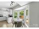 Breakfast nook with bay window and views of the outdoor deck area at 7425 Hubbard Woods Rd, Charlotte, NC 28269