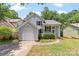 Charming single Gathering home with inviting curb appeal, attached garage and lush landscaping at 7425 Hubbard Woods Rd, Charlotte, NC 28269