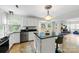 Kitchen with white cabinets, stainless steel appliances, kitchen island with seating, and granite countertops at 7425 Hubbard Woods Rd, Charlotte, NC 28269