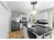 Kitchen with white cabinets, stainless steel appliances, kitchen island with seating, and granite countertops at 7425 Hubbard Woods Rd, Charlotte, NC 28269