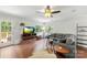 Spacious living room with hardwood floors, brick fireplace, and ample natural light at 7425 Hubbard Woods Rd, Charlotte, NC 28269