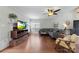 Spacious living room with hardwood floors, brick fireplace, and ample natural light at 7425 Hubbard Woods Rd, Charlotte, NC 28269