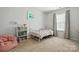Bright bedroom featuring a large window, neutral colors, and a comfortable bed at 78114 Rillstone Dr, Lancaster, SC 29720