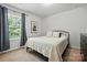 Cozy bedroom with a large window, neutral colors, and a comfortable bed at 78114 Rillstone Dr, Lancaster, SC 29720
