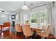 Bright dining area with a fireplace, hardwood floors, and large windows dressed with elegant white drapes at 78114 Rillstone Dr, Lancaster, SC 29720
