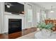 Close-up on a living room fireplace with dark hearth, bright windows, and elegant white drapery at 78114 Rillstone Dr, Lancaster, SC 29720