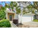 Charming home featuring a brick-accented entrance, vinyl siding, a two-car garage, and beautiful flowering trees at 78114 Rillstone Dr, Lancaster, SC 29720