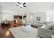 Spacious open-concept living area with hardwood floors, modern furnishings, and seamless flow to kitchen at 78114 Rillstone Dr, Lancaster, SC 29720