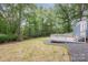Backyard view showing deck, landscaping and mature trees at 870 Family Dr, Midland, NC 28107