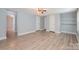 Spacious bedroom with light blue walls and neutral vinyl flooring, includes a ceiling fan and built in storage at 870 Family Dr, Midland, NC 28107